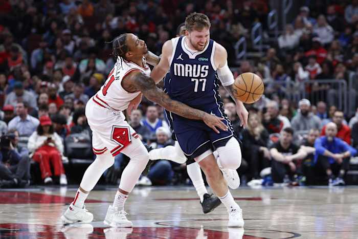 Chicago Bulls forward DeMar DeRozan (11) fouls Dallas Mavericks guard Luka Doncic (77) during the second half at United Center.